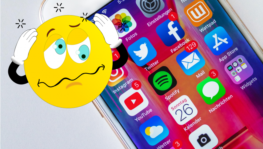Im Hintergrund ein Smartphone mit vielen bunten App-Symbolen. Im Vordergrund ein Smily, der sich die Hände an den Kopf hält, weil im schwindelig ist.